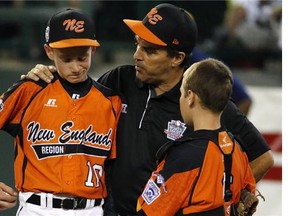 Cumberland manager David Belisle, center, talks with pitcher CJ Davock, left, and catcher Trey Bourque during the fifth inning of an elimination baseball game against Chicago at the Little League World Series tournament in South Williamsport, Pa., Monday, Aug. 18, 2014. Chicago won 8-7. (AP Photo/Gene J. Puskar)