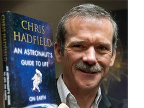 Retired Canadian astronaut Chris Hadfield holds a copy of his new book "An Astronaut's Guide to Life on Earth" while on a media tour in Montreal on November 27, 2013. Former astronaut Chris Hadfield's next adventure may involve prime-time TV. His book, "An Astronaut's Guide To Life On Earth," is the inspiration for a TV pilot being commissioned by ABC. THE CANADIAN PRESS/Ryan Remiorz