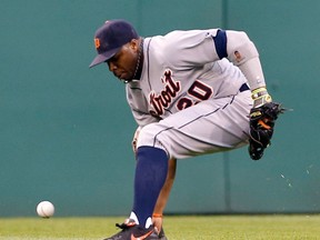 Detroit's Rajai Davis kicks the ball away on a hit by Pittsburgh's Josh Harrison who got to second on the play in the first inning Monday in Pittsburgh. (AP Photo/Keith Srakocic)