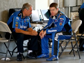 Carl Edwards, right, talks with crew chief Jimmy Fennig in the garage area during practice for a NASCAR Sprint Cup Series race at the Brickyard Indianapolis Motor Speedway. (Photo by Andy Lyons/Getty Images)