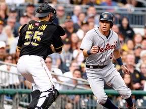 Montreal native Russell Martin, left, tags out Ian Kinsler of the Detroit Tigers in the first inning during inter-league play at PNC Park Tuesday in Pittsburgh. (Photo by Justin K. Aller/Getty Images)