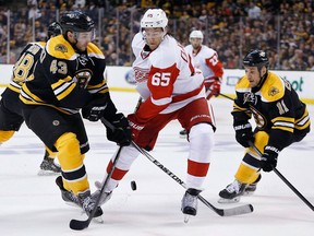 Boston's Matt Bartkowski, left, and Detroit's Danny DeKeyser battle for the puck during the first period in Game 5 of the Stanley Cup playoffs in Boston. (AP Photo/Michael Dwyer)