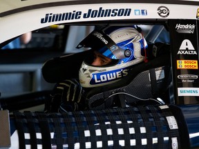 NASCAR driver Jimmie Johnson sits in his car in the garage during practice for the NASCAR Sprint Cup Series Pure Michigan 400 at Michigan International Speedway Friday in Brooklyn, Mich. (Photo by Gregory Shamus/Getty Images)