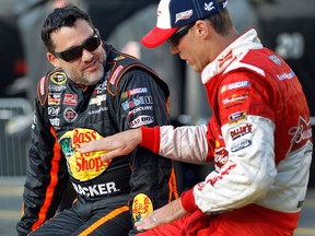 Tony Stewart, left, talks with Kevin Harvick earlier this year before qualifying for a NASCAR Sprint Cup series auto race at Charlotte Motor Speedway in Concord, N.C. (AP Photo/Terry Renna, File)