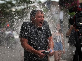 Windsor Star reporter Trevor Wilhelm endures the ice water challenge, over 20 litres of ice water thrown from the second floor balcony of The Windsor Star at 300 Ouellette Avenue Monday August 18, 2014.  (NICK BRANCACCIO/The Windsor Star)