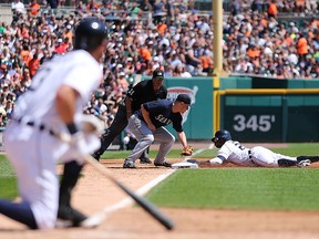 DETROIT, MI - AUGUST 17: Rajai Davis #20 of the Detroit Tigers slides safe into third base as Kyle Seager #15 of the Seattle Mariners attempts to make the tag during the third inning of the game at Comerica Park on August 17, 2014 in Detroit, Michigan. (Photo by Leon Halip/Getty Images) ORG XMIT: 477588173