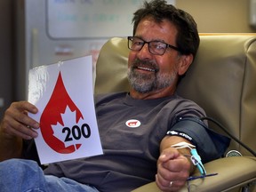 Jean Barrette donates blood for the 200th time at Canadian Blood Services on Grand Marais Road East Thursday August 21, 2014. (NICK BRANCACCIO/The Windsor Star)