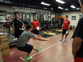 Spits defenceman Blake Coffey, left, undergoes fitness tests at training camp Monday. (TYLER BROWNBRIDGE/The Windsor Star)