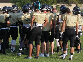 Members of the AKO football team take a break during practice at Jackson Park. (DAX MELMER/The Windsor Star)