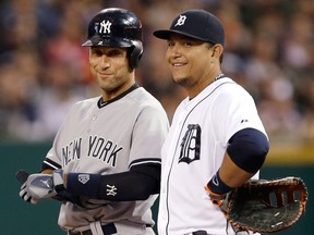 New York's Derek Jeter, left, laughs with Detroit first baseman Miguel Cabrera after hitting a single in the first inning Tuesday. (AP Photo/Paul Sancya)