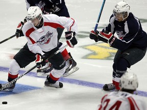 Windsor Spitfires Markus Soberg spins away from Cristiano DiGiacinto, right, during annual Blue vs. White Game at WFCU Centre August 28, 2014.  (NICK BRANCACCIO/The Windsor Star)