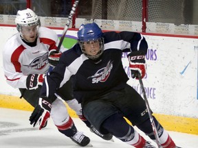 Windsor Spitfires Blake Coffey rounds the net while being chased by Aaron Luchuk of Team Blue during annual Blue vs. White Game at WFCU Centre August 28, 2014.  (NICK BRANCACCIO/The Windsor Star)
