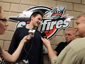 Spitfires rookie Logan Brown, centre, talks with members of the media, including The Windsor Star's Bob Duff, right. (TYLER BROWNBRIDGE/The Windsor Star)