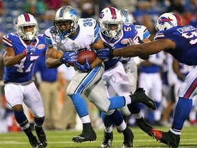 Detroit Lions running back George Winn, left, runs with the ball against the Buffalo Bills during the second half in Orchard Park. (AP Photo/Bill Wippert)