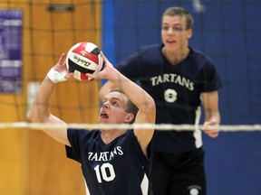 Walkerville's Lucas Palmer, front, sets the ball in front of his brother Liam Palmer against Catholic Central in playoff volleyball action at Walkervillle. (NICK BRANCACCIO/The Windsor Star)