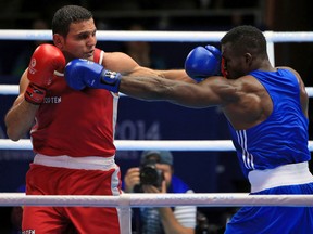 Windsor's Samir El-Mais, left, fights Nigeria's Efetobor Apochi in the heavyweight (91kg) semifinal at the Commonwealth Games in Glasgow. (AP Photo/PA, Peter Byrne)