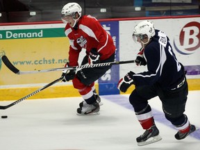 Spits forward Markus Soberg, top, carries the puck against Andrew Burns at the WFCU Centre. (NICK BRANCACCIO/The Windsor Star)