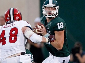 Michigan State quarterback Connor Cook, right, is pressured by linebacker Ben Endress of the Jacksonville State Gamecocks Friday in East Lansing, Mich. (Photo by Duane Burleson/Getty Images)