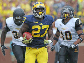 Michigan's Derrick Green, centre, runs for a long gain during the second half of the game against Appalachian State at Michigan Stadium. (Photo by Leon Halip/Getty Images)