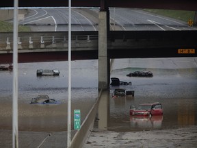Vehicles sit submerged in water along I-75 August 12, 2014 in Royal Oak, Michigan. (Photo by Joshua Lott/Getty Images)