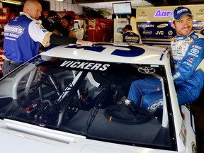 Brian Vickers, driver of the #55 Aaron's Dream Machine Toyota, gets in his car during practice for the NASCAR Sprint Cup Series Pure Michigan 400 at Michigan International Speedway on August 16, 2014 in Brooklyn, Michigan. (Jerry Markland/Getty Images)