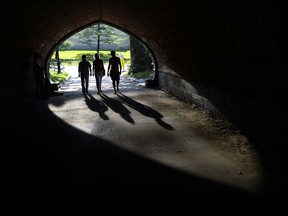 People walk through a tunnel near the Belvedere Castle in Central Park on May 30, 2013  in New York City.  (TIMOTHY CLARYAFP/Getty Images)