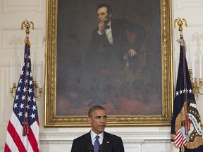 US President Barack Obama, standing beneath a portrait of 16th US President Abraham Lincoln, speaks about the situation in Iraq in the State Dining Room at the White House in Washington, DC, August 7, 2014. Obama said he authorized air strikes and relief supply drops in Iraq to prevent "genocide" by Islamist extremists against minorities. "We can act, carefully and responsibly, to prevent a potential act of genocide," Obama said, in an address as he announced military action.  AFP PHOTO / Saul LOEBSAUL LOEB/AFP/Getty Images