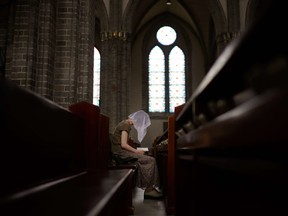 In a photo taken on August 6, 2014, a Catholic worshipper reads from a Bible at the Myeongdong cathedral in Seoul. When Pope Francis visits South Korea on August 14, 2014, he will find a thriving Catholic community with a social and political influence that belies its minority status in one of Christianity's most muscular Asian strongholds.     AFP PHOTO / Ed JonesED JONES/AFP/Getty Images