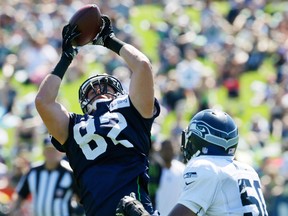 LaSalle's Luke Willson, left, makes a catch as outside linebacker K.J. Wright, right, defends, during training camp in Renton, Wash. (AP Photo/Ted S. Warren)