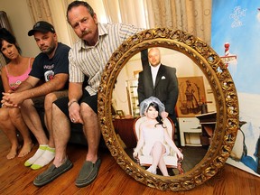 WINDSOR, ON.: AUGUST 26, 2014 --  Shelley Voakes, Peter Campbell and Randy Voakes (left to right) sit next to a wedding photo of Priscilla and Peter Campbell in Essex on Tuesday, August 26, 2014. Artist and activist Priscilla Campbell passed away suddenly on Sunday.                (Tyler Brownbridge/The Windsor Star)
