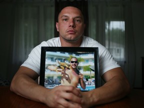 Robert Ouellette, 32, is pictured with a photo of his late brother, Joseph Pazner, at his home in Windsor, Ont., Monday, August 11, 2014.  Ouellette spread his brother's ashes onto the field while at a Toronto Blue Jays game Friday, August 8, 2014.  His brother passed Feb.1, 2014 from a heart attack.   (DAX MELMER/The Windsor Star)