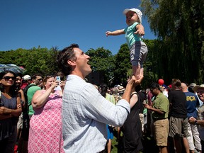 Liberal Leader Justin Trudeau balances his 5-month-old son Hadrien on his hand while attending the B.C. Day Liberal barbeque in Vancouver, B.C., on Monday August 4, 2014. THE CANADIAN PRESS/Darryl Dyck