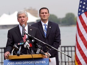 Michigan Gov. Rick Snyder gives his opening remarks during a news conference regarding the planned new $2 billion bridge linking Detroit and Windsor, Ontario, Wednesday, July 30, 2014 in Windsor. Michigan and Canada have appointed members of an authority to oversee construction of the bridge. (AP Photo/Detroit News, Clarence Tabb Jr.)