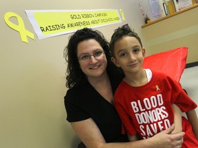 Kate Aversa and her son Luca at Canadian Blood Services in Windsor, Ontario on August 28, 2014.  Luca Aversa was diagnosed with neuroblastoma eight years ago when he was only four months old.  As part of his treatment Luca underwent chemotherapy and needed surgery to remove a large tumour in his abdomen.  This required Luca to receive a significant number of blood transfusions.  (JASON KRYK/ The Windsor Star)