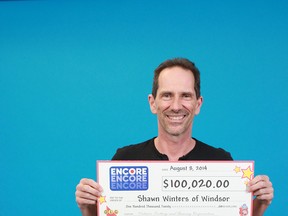 Shawn Winters of Windsor poses with his cheque for $100,020. (HANDOUT/The Windsor Star)