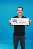 Shawn Winters of Windsor poses with his cheque for $100,020. (HANDOUT/The Windsor Star)