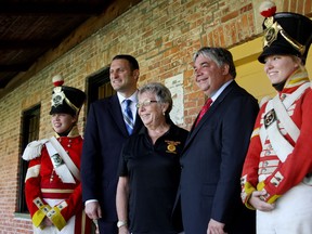 From left to right, heritage interpreter Paige McDonald, Essex MP Jeff Watson, Shores of Erie chairperson Karen Gyorgy, Minister Peter Van Loan and heritage interpreter Kaila Hawksworth pose for a photo at Fort Malden Thursday, Aug. 28, 2014. The federal government awarded a $62,000 grant to the Shores of Erie Wine Festival. (RICK DAWES/The Windsor Star)