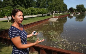 Jennifer Poisson, a resident of Andrew Cres. in Belle River, looks over Belle River Canal where hundreds of fish have turned up dead, Friday, August 15, 2014.  (DAX MELMER/The Windsor Star)