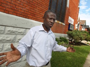 Kofi Yeboah, co-pastor at All Nations Full Gospel Church, explains all the repairs that need to be made to the church, Friday, August 29, 2014.  Yeboah and his wife, pastor Abena Yeboah, are asking the community for donations to help repair the church. (DAX MELMER/The Windsor Star)