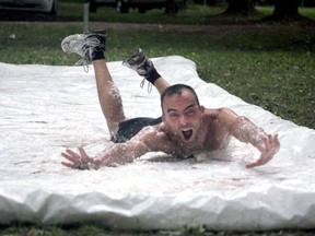 Dan Allaire, WRACE vice president, goes down the slip and slide at the Wet and Wildlife Hawk Run at Holiday Beach Sunday, Aug. 24, 2014. (JOEL BOYCE/The Windsor Star)