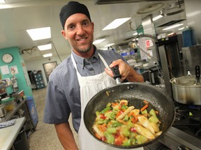 Kevin Cassetta, a dietary helper at Windsor Regional Hospital - Met Campus, cooks up a chicken stir-fry, Tuesday, August 12, 2014.  (DAX MELMER/The Windsor Star)