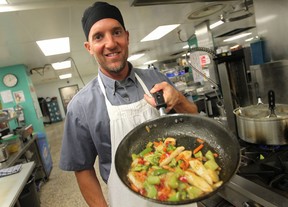 Kevin Cassetta, a dietary helper at Windsor Regional Hospital - Met Campus, cooks up a chicken stir-fry, Tuesday, August 12, 2014.  (DAX MELMER/The Windsor Star)