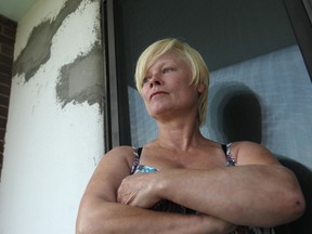 Carol Taylor stands next to cracks in the wall on her sixth floor balcony at 445 Glengarry Ave. Friday, August 8, 2014.  (DAX MELMER/The Windsor Star)