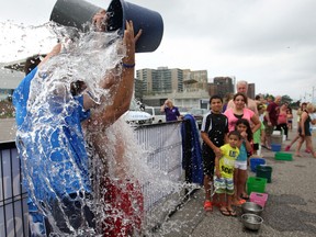Chris Taylor, left, and Santino Albano participate in the Windsor/Essex ALS Ice Bucket Challenge at the Riverfront Festival Plaza,  Sunday, August 24, 2014.  Approximately 40 people took part in the event with donations going to the ALS Society of Windsor/Essex.  (DAX MELMER/The Windsor Star)