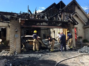 LaSalle firefighters clean up following a house fire on Crystal Harbour Drive Thursday, Aug. 14, 2014. (Twitpic: DAN JANISSE/The Windsor Star)