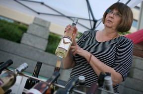 WINDSOR, ONT.: MAY 30, 2014 -- Katy O'Brien, from Cooper's Hawk Winery, sells bottles of wine on the opening day of the Downtown Farmer's Market at Charles Clark Square in downtown Windsor, Saturday, May 31, 2014.  This is the first year that farmer's markets are allowed to sell local wines.  (DAX MELMER/The Windsor Star)