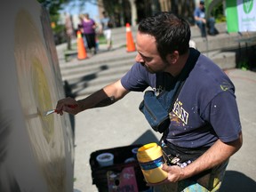 WINDSOR, ONT.: In this file photo, Jay Raven, a local artist and owner of South Detroit Studio, performs a live mural on the opening day of the Downtown Farmer's Market at Charles Clark Square in downtown Windsor, Saturday, May 31, 2014.   (DAX MELMER/The Windsor Star)