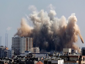 Smoke, dust and debris rise over Gaza City after an Israeli strike, Friday, Aug. 8, 2014, as Israel and Gaza militants resumed cross-border attacks after a three-day truce expired and Egyptian-brokered talks on a new border deal for blockaded Gaza hit a deadlock. (AP Photo/Hatem Moussa)