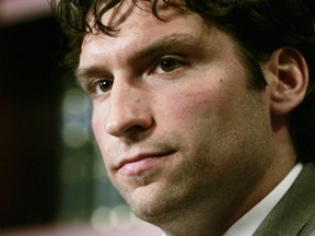 Former NHL player Steve Moore listens to a question during a news conference in 2004. A settlement has been reached in Moore's lawsuit against Todd Bertuzzi for his career-ending hit during an NHL game 10 years ago. (AP Photo/The Canadian Press, Adrian Wyld)