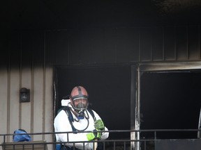 A fire investigator surveys the damage following a blaze at 76 Tecumseh Rd. E. in Windsor on Sunday, August 3, 2014 in Windsor, Ontario. (DAX MELMER/The Windsor Star)